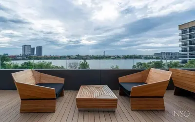 a patio with two chairs and a table on a balcony at Luxury Riverside condo in Nonthaburi