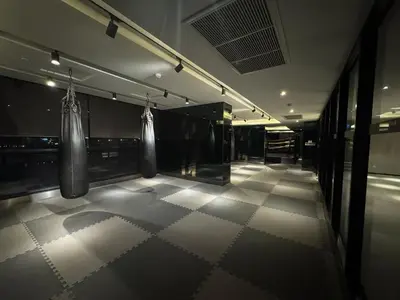 a gym with two boxing bags hanging from the wall at Luxury Riverside condo in Nonthaburi