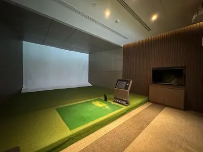 a room with a tv and a green floor at Luxury Riverside condo in Nonthaburi