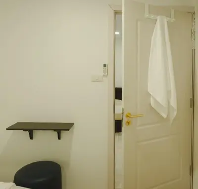 a bathroom with a door with a towel hanging on it at Big unit for 8 people, city center Silom in Bangkok