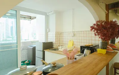 a kitchen with a table and a counter top at Big unit for 8 people, city center Silom in Bangkok
