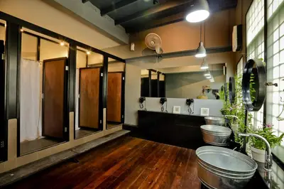 a bathroom with two sinks and a toilet in it at Bangkok Bed and Bike in Bangkok