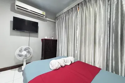 a bedroom with a bed with two towels on it at Sunshiny-BB Hostel near Punnavithi BTS station in Bangkok
