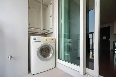 a washing machine in a kitchen next to a window at Ivy Thonglor Luxury Condo with Swimming Pool, Fast Wifi in Bangkok