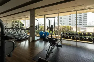 a gym with treadmills and machines in a building at Ivy Thonglor Luxury Condo with Swimming Pool, Fast Wifi in Bangkok