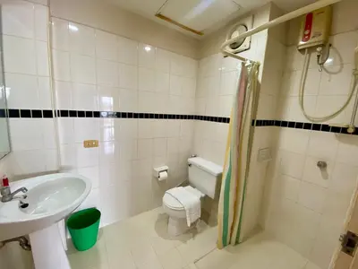a bathroom with a sink and a toilet and a shower at ศรีย่าน เรสซิเดนซ์ Sriyan Residence in Dusit
