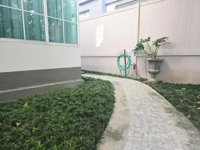 a brick path next to a building with a potted plant at Elegant Home near MRT Central WestGate and Central WestVille 3 to 10 Min Drive