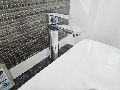 a bathroom sink with a chrome bathroom faucet at Elegant Home near MRT Central WestGate and Central WestVille 3 to 10 Min Drive