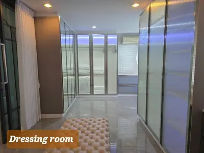 a dressing room with a bench in the middle of a room at Elegant Home near MRT Central WestGate and Central WestVille 3 to 10 Min Drive