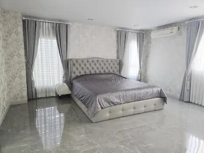 a bedroom with a bed and two windows at Elegant Home near MRT Central WestGate and Central WestVille 3 to 10 Min Drive