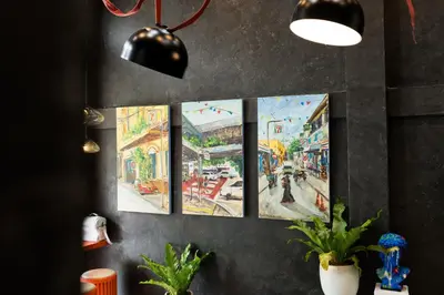 a group of paintings hanging on a wall at 5loft Anti-Hotel, Silom, Bangkok in Bangkok