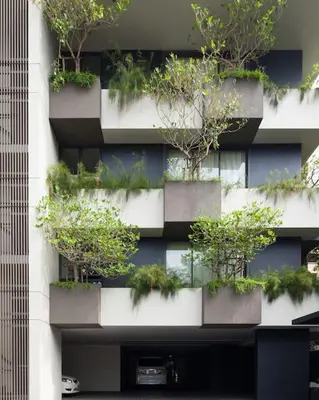 a building with potted plants on the side of it at Bangkok Tryp in Bangkok