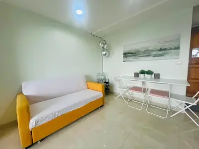 a room with a bed and a table and chairs at The Station Condo1 in Bangkok