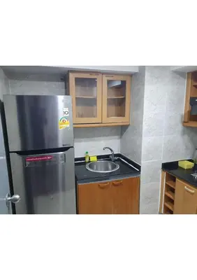a kitchen with a stainless steel refrigerator and a sink at Omni Tower Nana- Fully Furnished Apartments Bangkok in Bangkok