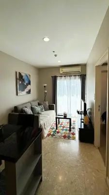 a living room with a bed and a couch at 1BR Thonglor BTS InfinityPool overlooking city in Bangkok