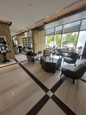 a living room with couches and tables and windows at 1BR Thonglor BTS InfinityPool overlooking city in Bangkok