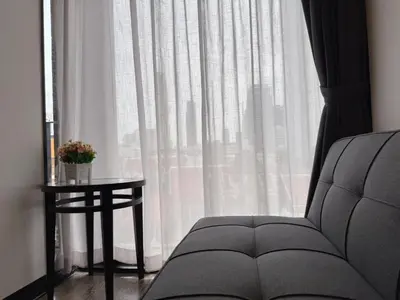 a window with a chair and a table in front of it at Cozy Mini Theatre - Victory Monument - 3 pax in Bangkok