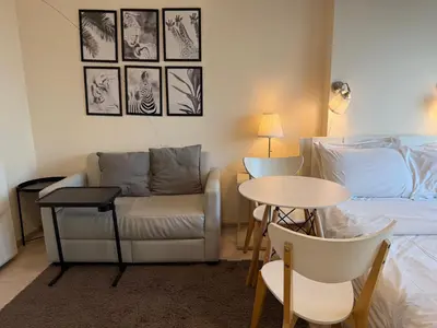 a bedroom with a bed and a couch and a table at Cozy5Living in Bangkok 60m to MRT near chatuchank in Ban Bang Khwang