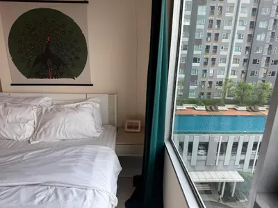 a bedroom with a bed and a large window at Cozy7 Living in Bangkok60 m to MRTnear chatuchank in Ban Bang Khwang