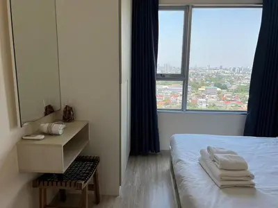 a bedroom with a bed and a mirror and a window at Cozy8Living in Bangkok 60mto MRT in Ban Bang Khwang