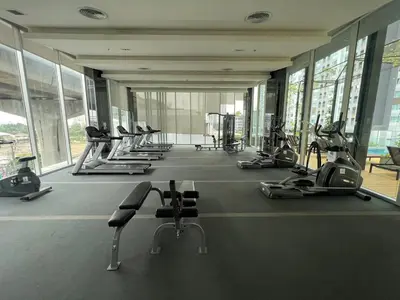 a gym with a row of treadmills and machines at Cozy9Living in Bangkok 60mto MRT in Ban Bang Khwang