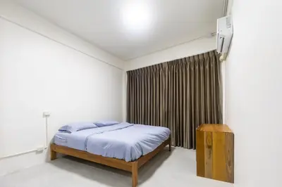 a bedroom with a bed and a window at WJ Luxury Sathorn in Bangkok