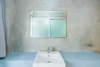 a bathroom with a white sink and a mirror at Five Stars Residence in Bangkok