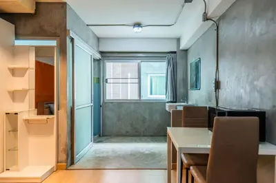a kitchen with a table and a window at Five Stars Residence in Bangkok