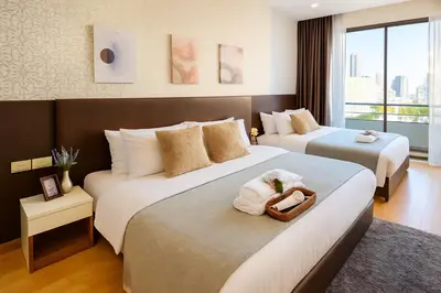 a hotel room with two beds with towels on them at Great Balcony with 2 Beds Executive Unit in Bangkok