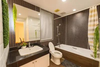 a bathroom with a toilet and a tub and a sink at Great Balcony with 2 Beds Executive Unit in Bangkok