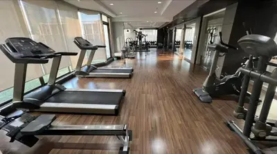a gym with several treadmills and elliptical machines at Great Balcony with 2 Beds Executive Unit in Bangkok