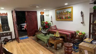 a living room with a couch and a table at Baan alisa 13 in Nonthaburi
