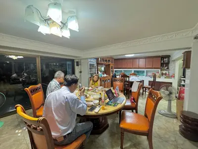 a group of people sitting at a table in a restaurant at Baan alisa 13 in Nonthaburi