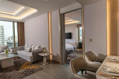 a hotel room with a couch and a bed at Grande Centre Point Prestige Bangkok in Bangkok