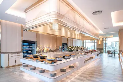 a kitchen with a counter with pots and pans at Grande Centre Point Prestige Bangkok in Bangkok