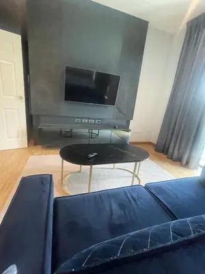a living room with a couch and a flat screen tv at Maxim in Pak Kret