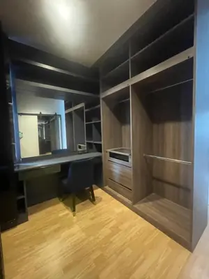 a kitchen with a desk and a chair in a room at Maxim in Pak Kret