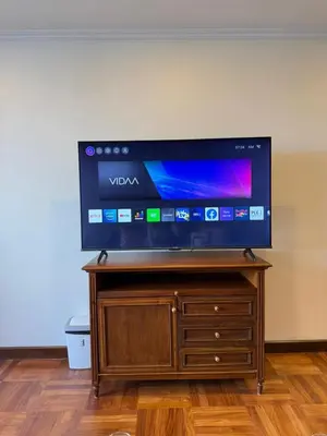 a flat screen tv sitting on top of a wooden stand at Chic Bangkok Escape & Fast Wifi in Bangkok