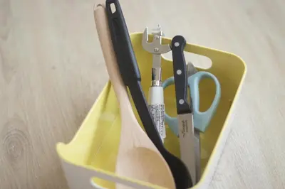 a yellow container with scissors and other kitchen utensils at Knightsbridge Duplex Tiwanon by Natcha in Nonthaburi
