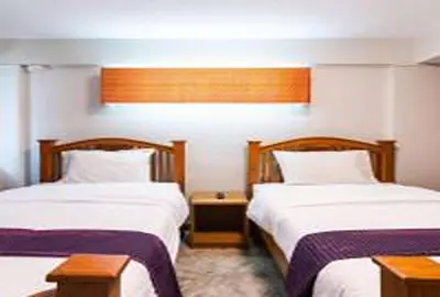 a hotel room with two beds and a window at xx GO INN Khaosan Road Bangkok - โก อินน์ ถนนข้าวสาร in Bangkok