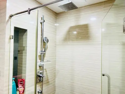 a shower with a glass door in a bathroom at Klass Langsuan Condo in Bangkok