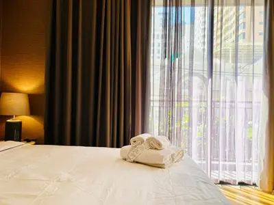 a hotel room with a bed with towels on it at Klass Langsuan Condo in Bangkok