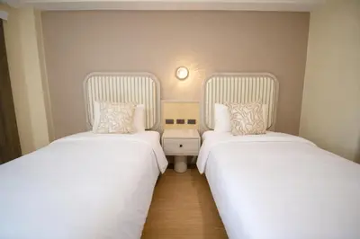 two beds sitting next to each other in a room at Ranana Bangkok in Bangkok