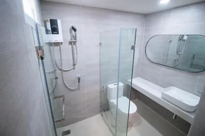 a bathroom with a shower and a toilet and a sink at Ranana Bangkok in Bangkok