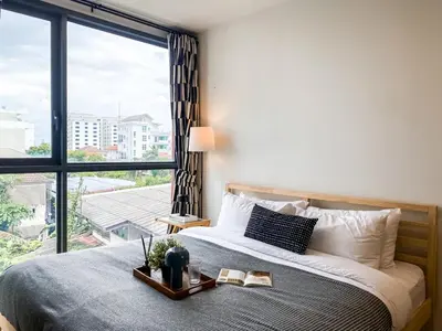 a bedroom with a bed and a large window at Modern-Design Apt 45 sqm - Ultra Fast WiFi - Ekamai in Bangkok