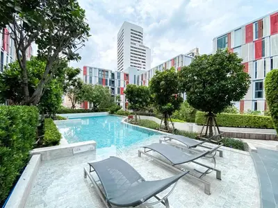 a swimming pool with two lounge chairs and a building at Modern-Design Apt 45 sqm - Ultra Fast WiFi - Ekamai in Bangkok