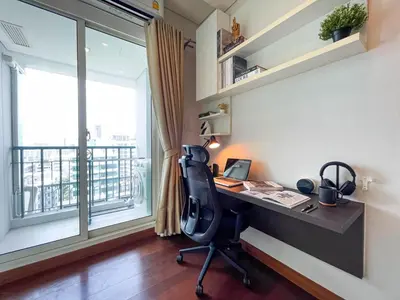 an office with a desk and a window and a desk and chair at Near BTS Thong Lor l Workspace and Kitchen l Sontana in Bangkok