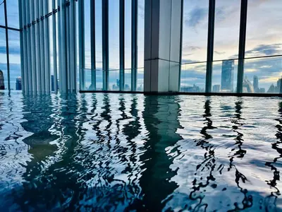 a view of a building with a pool of water at Hyde Sukhumvit 11 Bankok in Bangkok