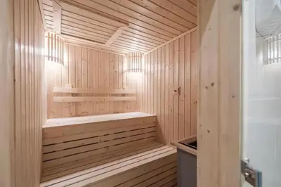 a wooden sauna with a bench in a wooden at Hyde Sukhumvit 11 Bankok in Bangkok