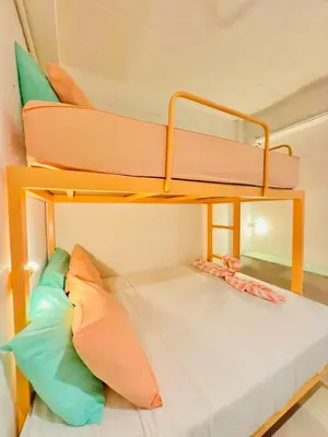 a bunk bed in a room with pillows at Lazy Sunday Khaosan Hotel in Bangkok